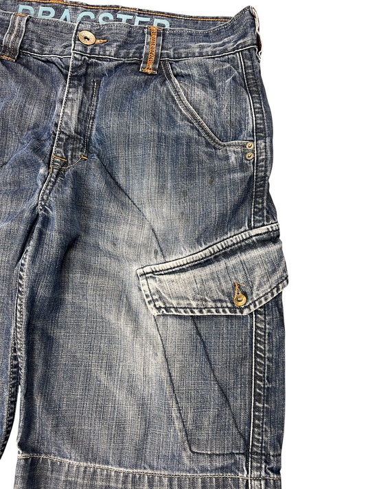 Y2K denim cargo jorts, angled view showing the fade and cargo pocket