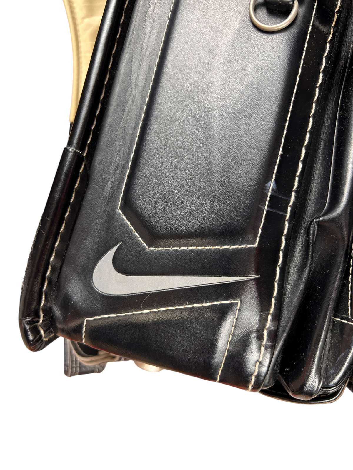 Nike Randoseru black and cream, red Swoosh - corner of the flap with embossed Swoosh