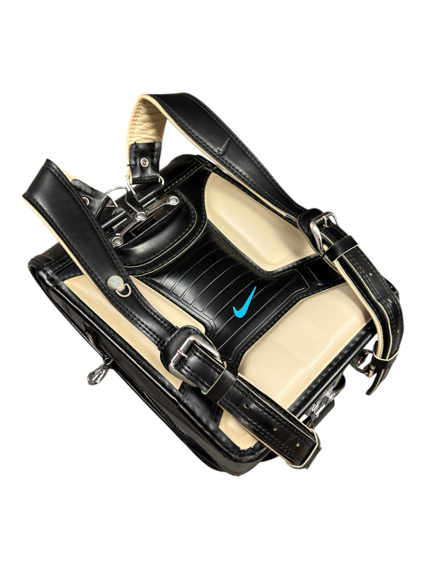 Nike Randoseru black and cream, blue Swoosh - three-quarter view of straps and buckles