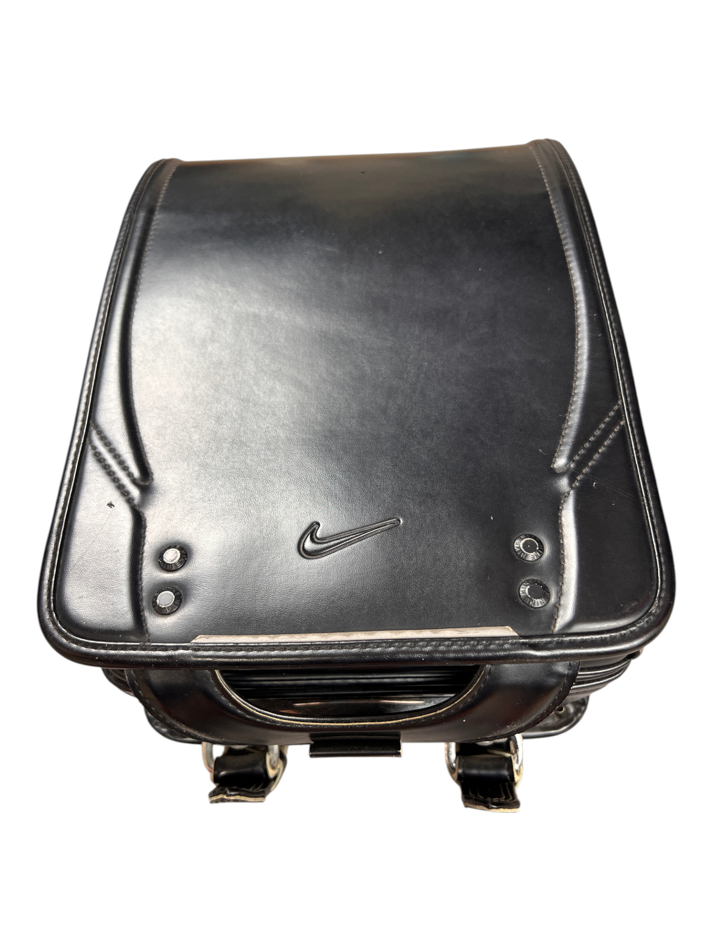 Nike Randoseru black and cream, blue Swoosh - front flap from a low angle with tonal Swoosh