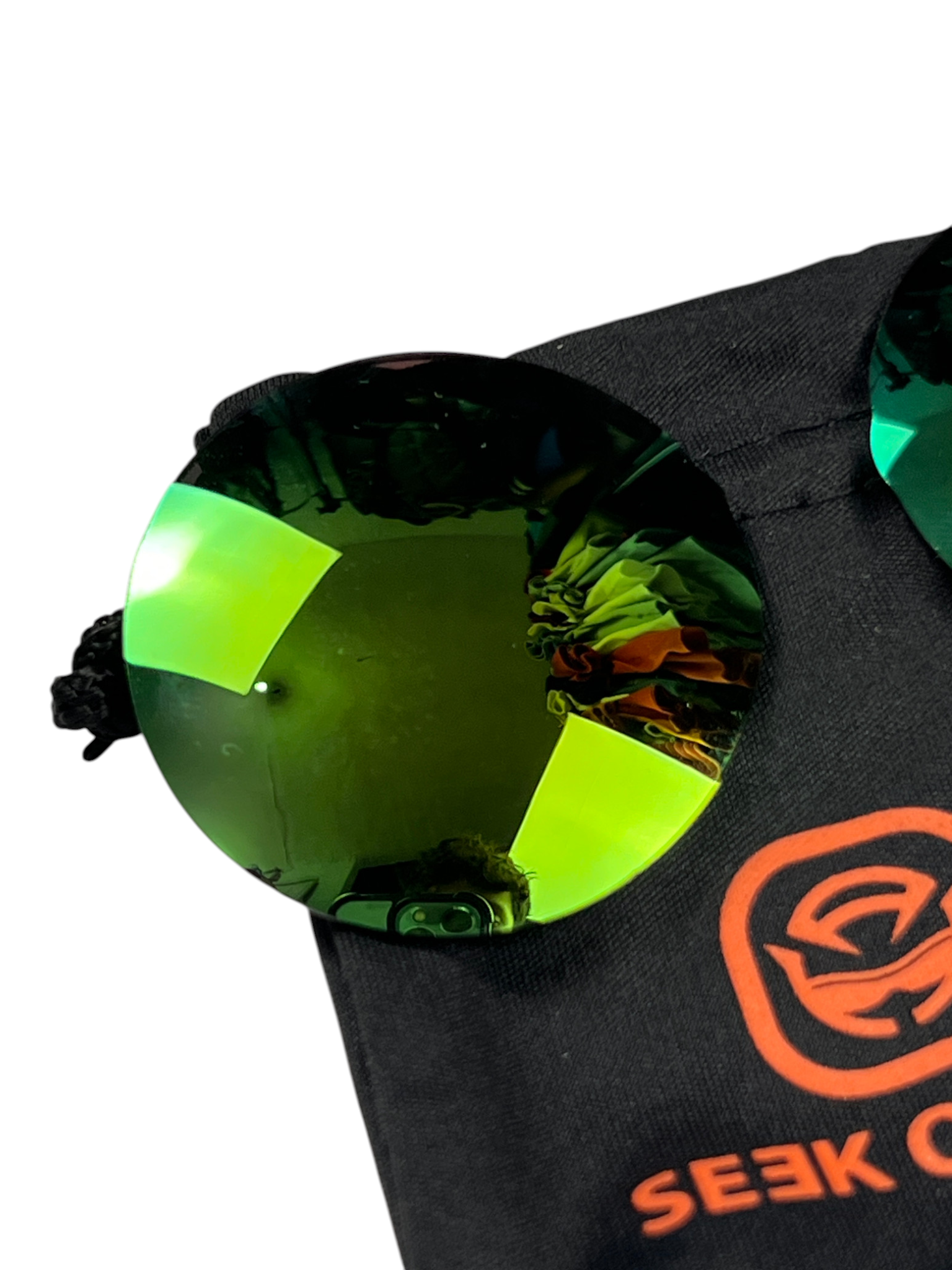 Spare Seek Optics green lenses in their pouch for the Oakley Madman