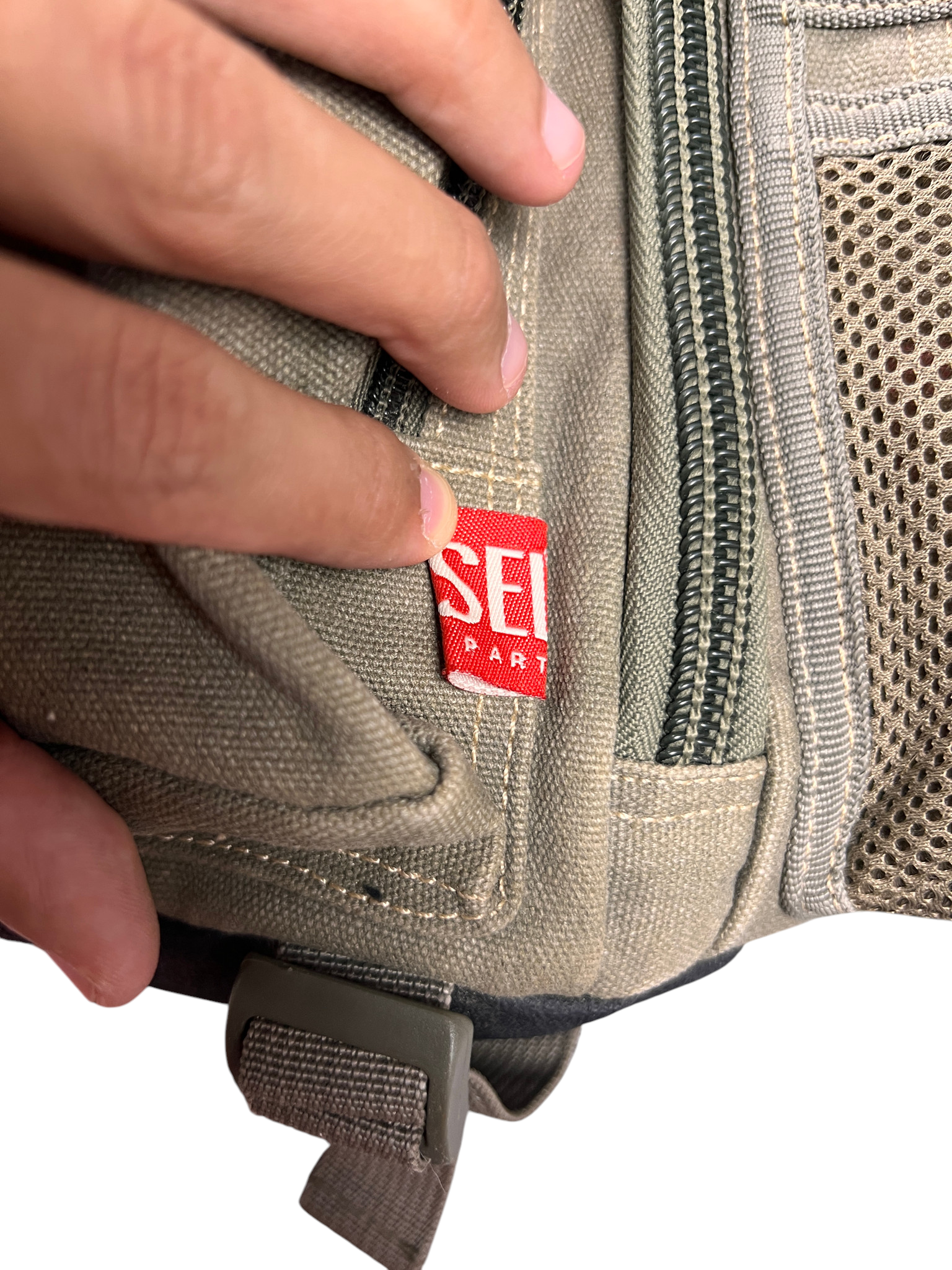 Detail of the mesh pocket zip pull on the Y2K Diesel bag
