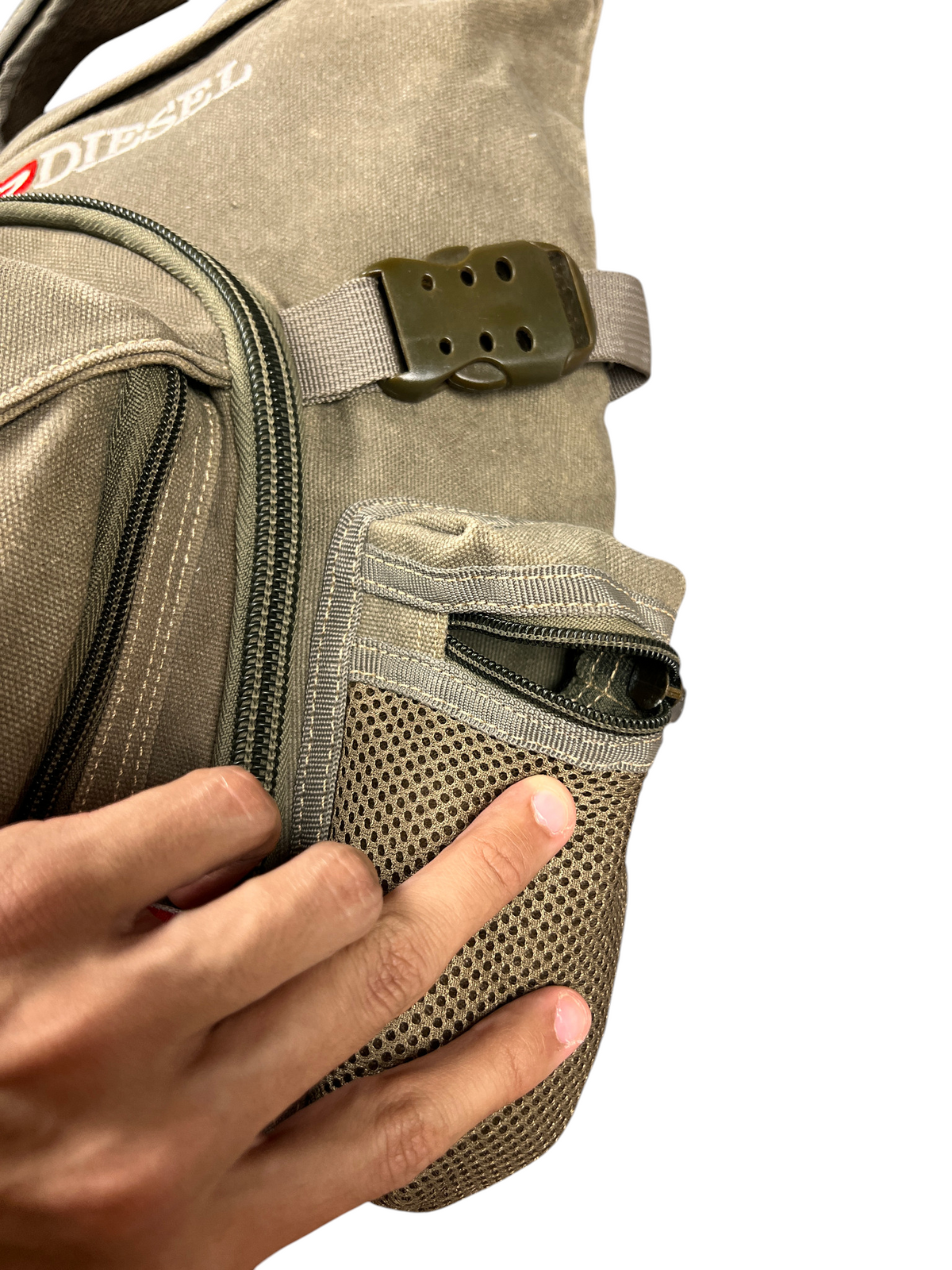 Mesh side pocket of the Diesel Y2K bag opened by hand